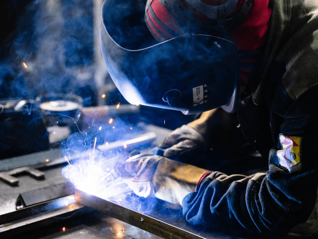 man welding steel